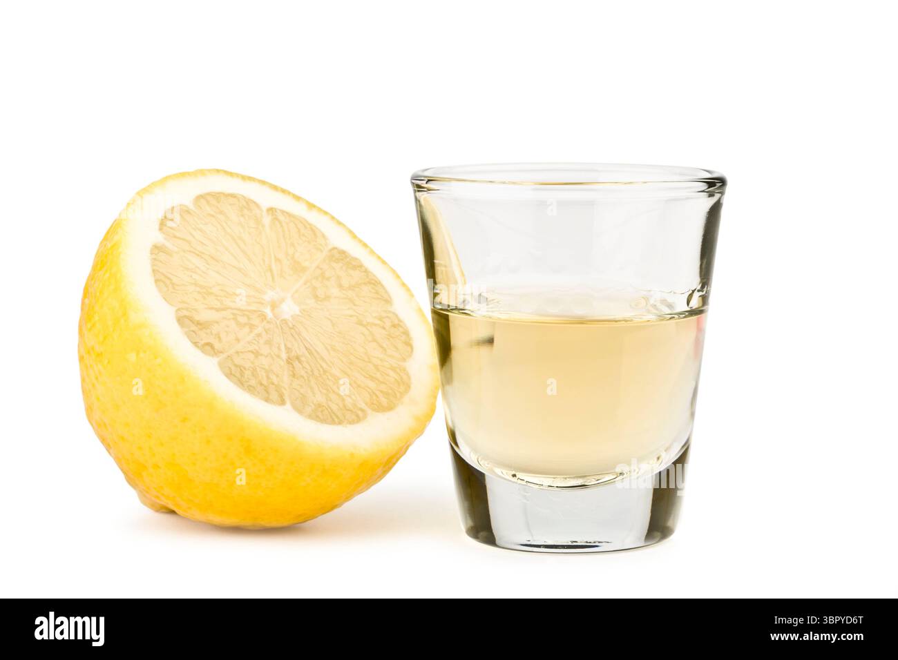 tequila tourné avec un demi-citron sur fond blanc Banque D'Images