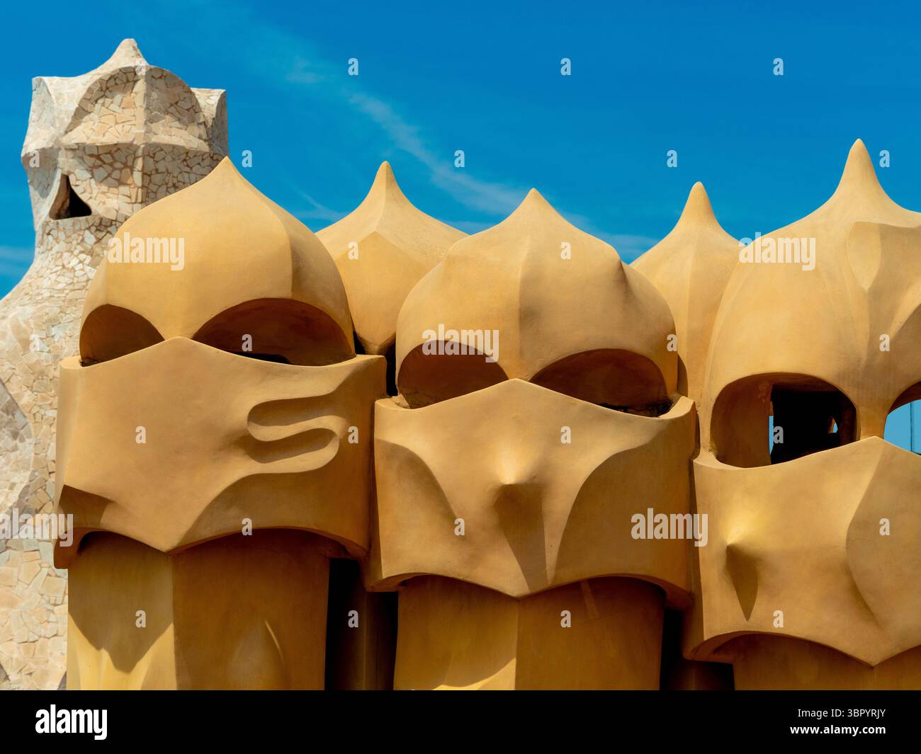 Un groupe de cheminées aux formes abstraites, parfois comparées à des casques médiévaux, sur la célèbre terrasse sur le toit de Casa Milà à Barcelone, en Espagne. Banque D'Images