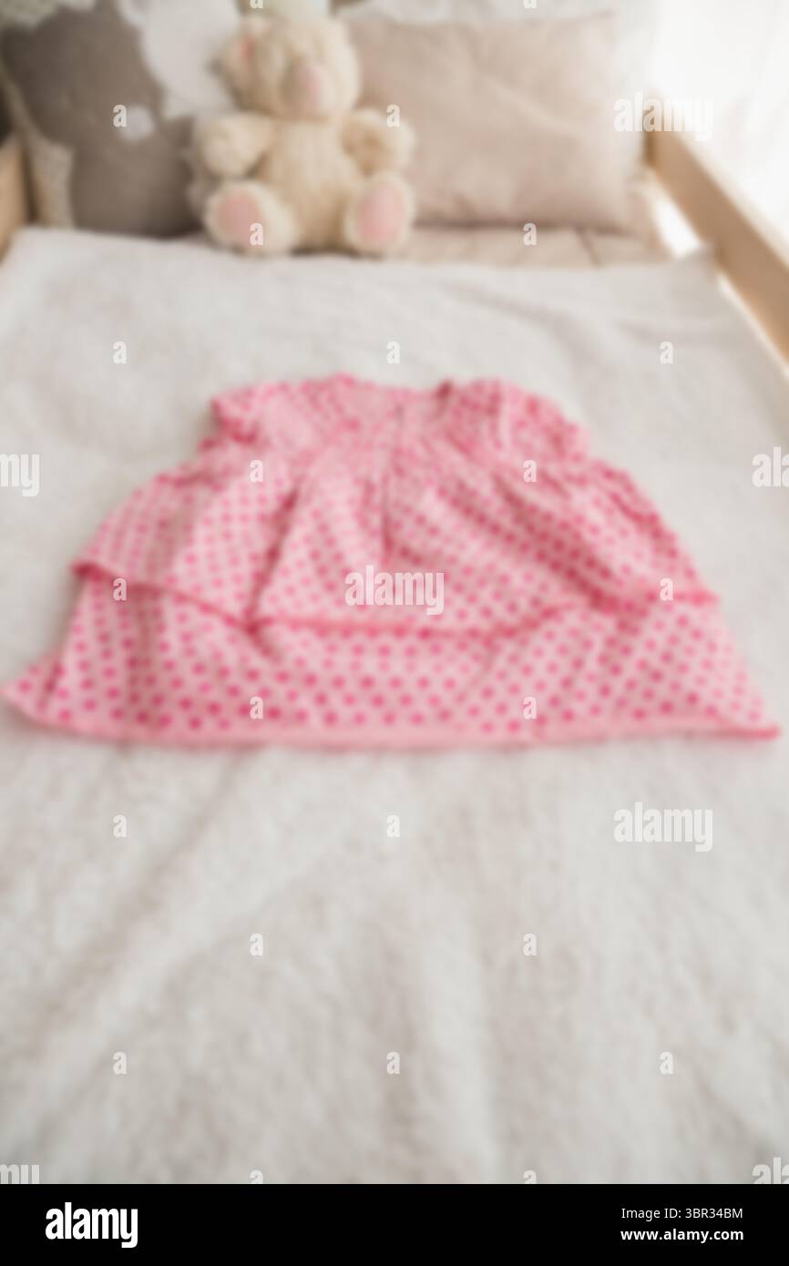 Vue à angle élevé d'un jouet en peluche par vêtements sur le lit Banque D'Images