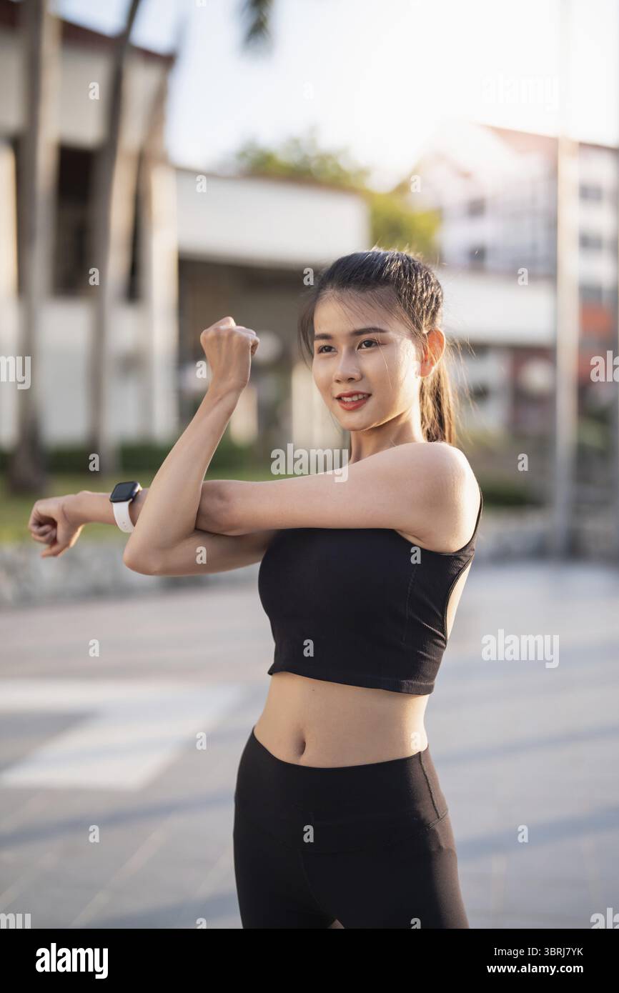 Femme asiatique saine active exerçant des athlètes dans des vêtements de fitness Sunrise sport Girl devant la motivation de la ville pour un mode de vie sain Banque D'Images