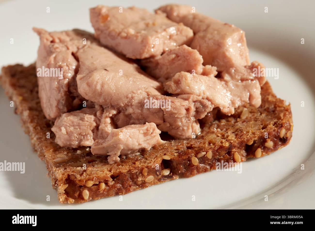 Sandwich au foie de morue ouvert sur pain pumpernickel Banque D'Images