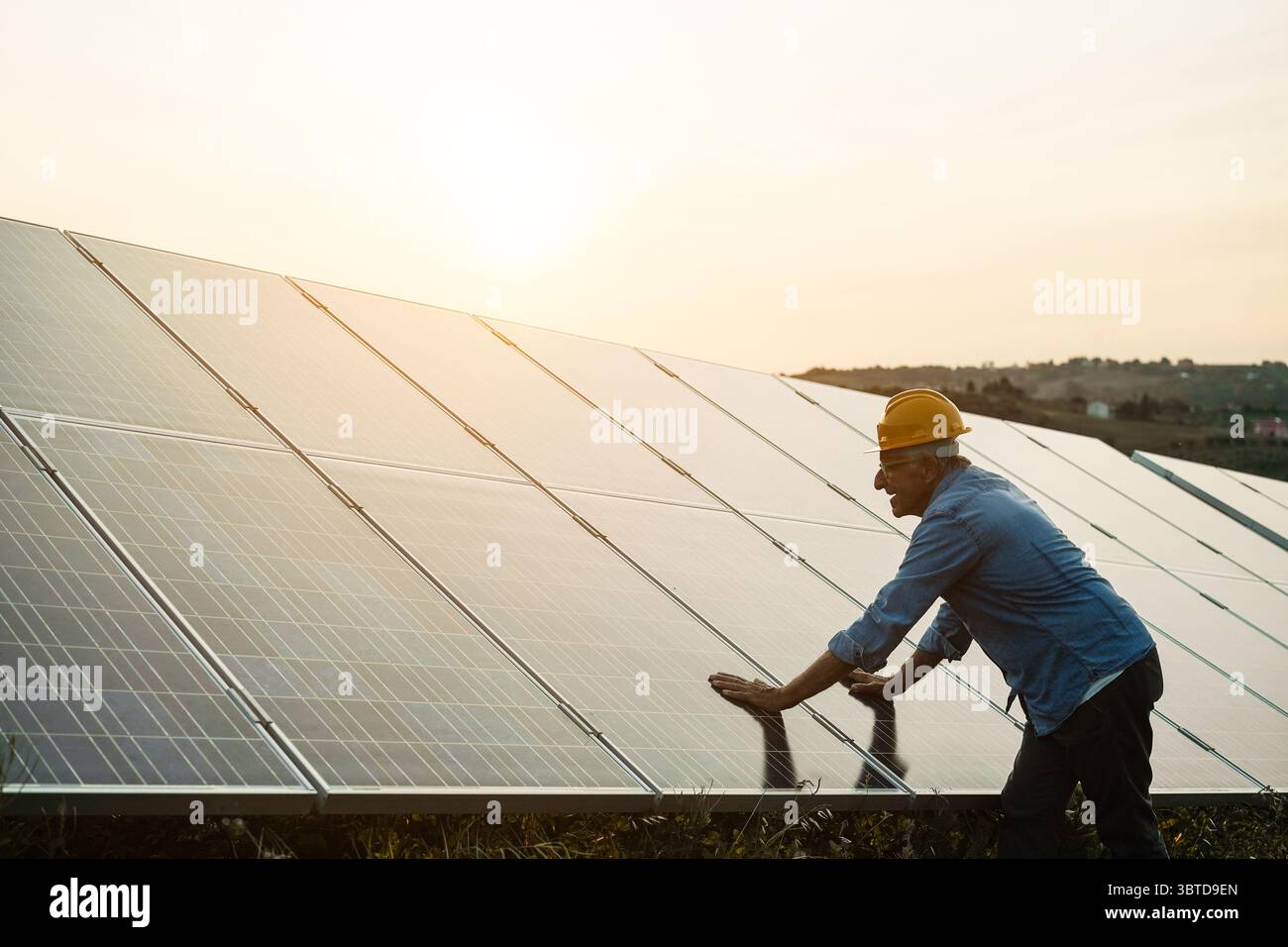 Homme travaillant à la station de panneaux solaires - concept d'énergie verte renouvelable - Focus sur le visage Banque D'Images