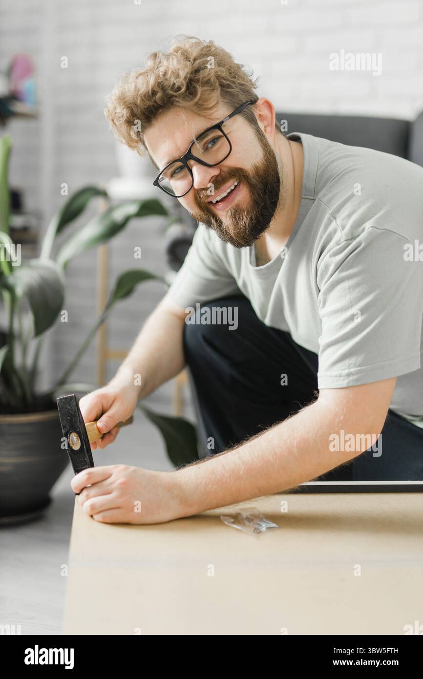 Portrait de l'homme assemblant des meubles. Faites-le vous-même assemblage de meubles à la maison Banque D'Images