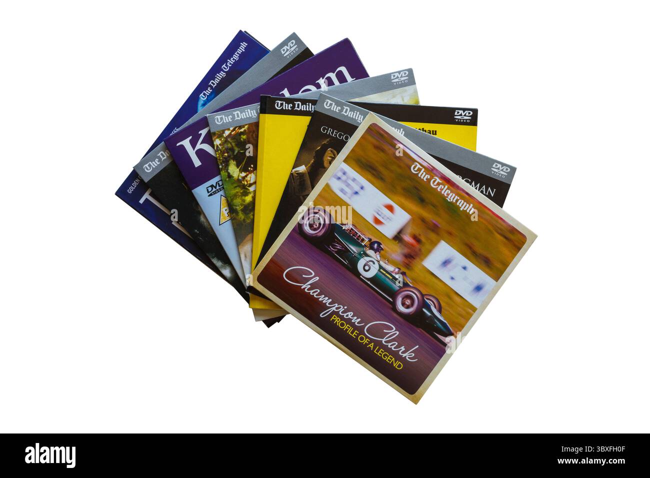 Pile de DVD gratuits donnés avec le Daly Telegraph avec Champion Clark profil d'un DVD de légende Jim Clark sur le dessus isolé sur fond blanc Banque D'Images