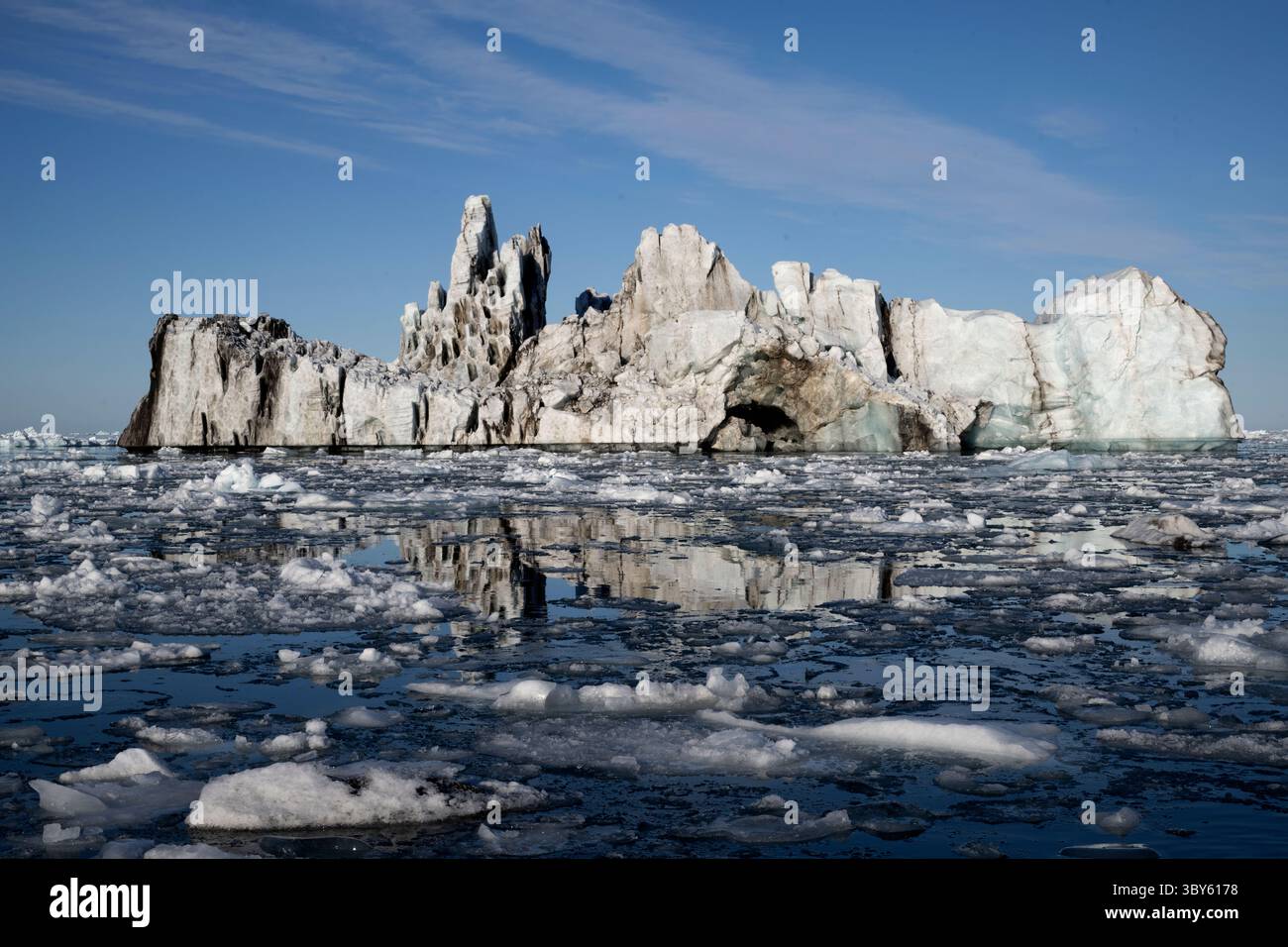 Cette photo a été prise un jour sans vent et montre des icebergs et de la glace reflétés dans les eaux lisses de Vikingebugt, dans l'est du Groenland, en Europe du Groenland Banque D'Images