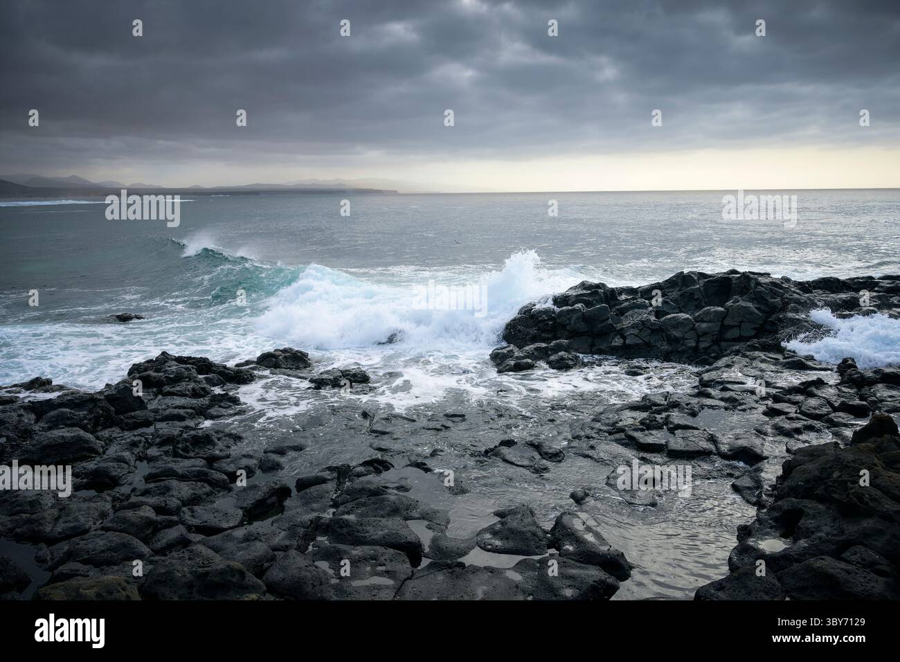 Mer agitée et nuages sombres sur la plage volcanique noire de Los Lagos, Fuerteventura, îles Canaries, Espagne, Europe Banque D'Images