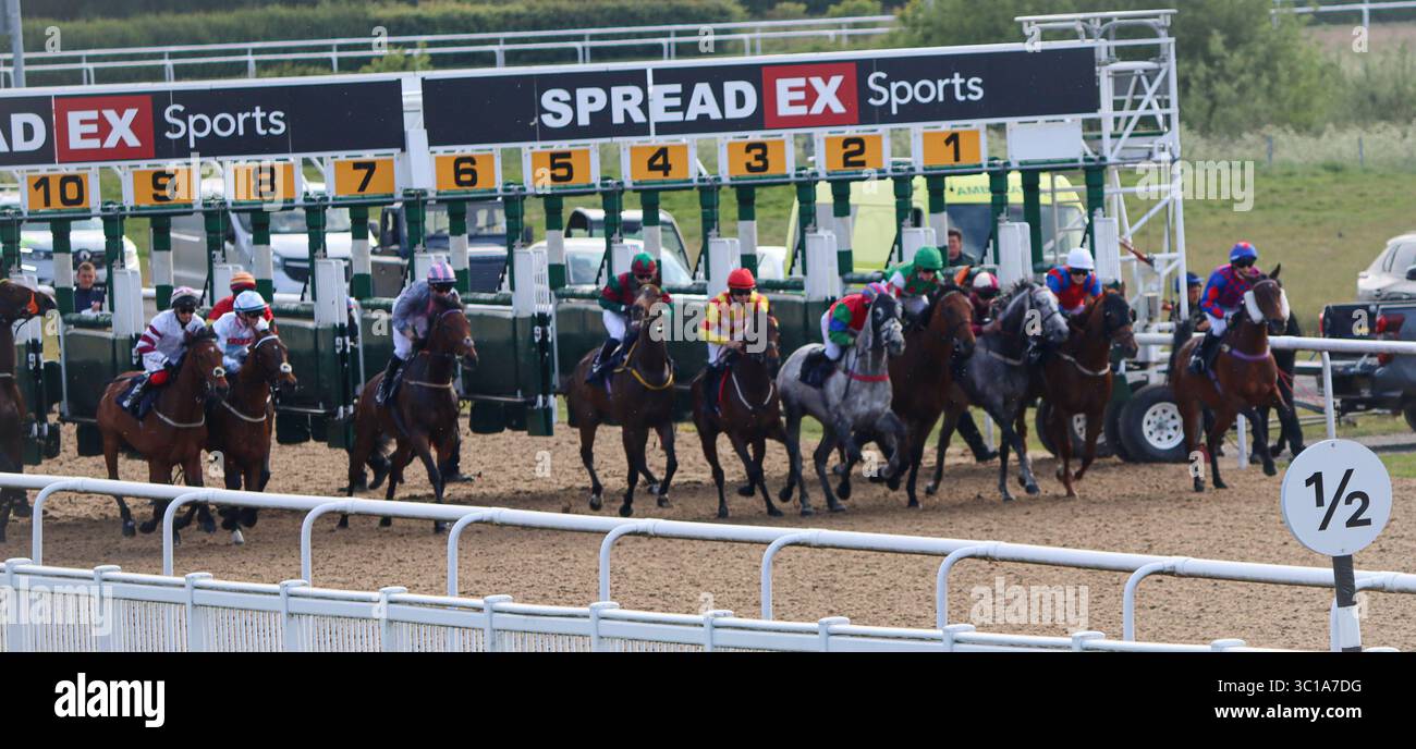 la course de chevaux commence avec de nombreux chevaux et jockeys Banque D'Images