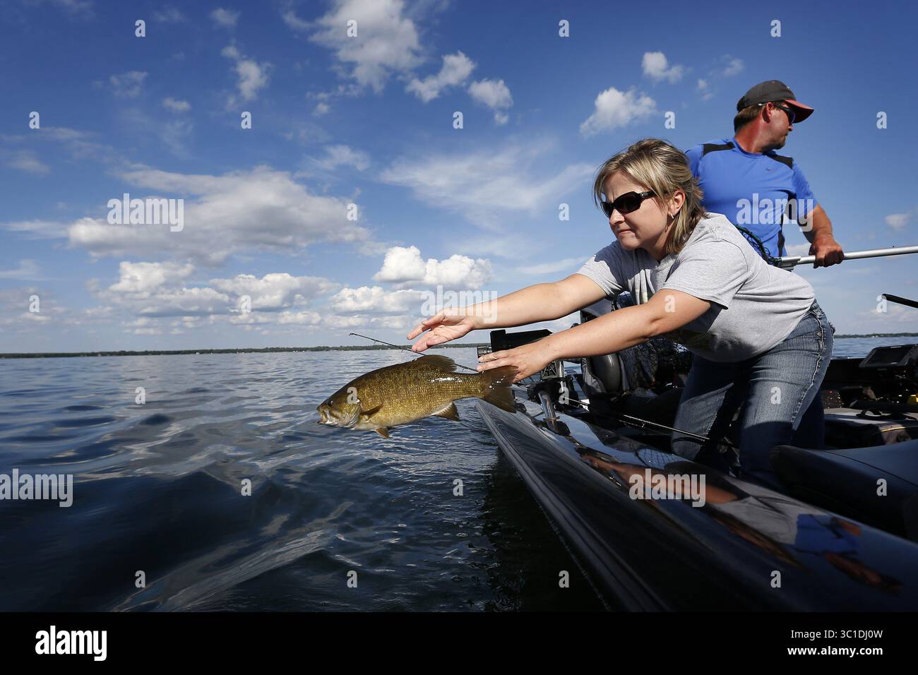 21 juillet 2015 - Isle, MN, États-Unis - Suzy Anderson a jeté un petit bar à bouche dans le lac des mille Lacs mardi. Le département des ressources naturelles du Minnesota a annoncé aujourd'hui que le relevé des nappes de la semaine dernière sur les récoltes estimées, les rejets et les morts de dorés jaunes sur le lac mille Lacs au cours des deux premières semaines de juillet a montré des augmentations drastiques qui pourraient amener l'État à atteindre sa limite d'ici juillet 29. - Le 21 juillet 2015, Isle, MN, Une ''tempête parfaite'' d'événements pourrait amener l'État à fermer la pêche au doré jaune sur le lac mille Lacs le mois prochain -- un mouvement sans précédent sur les lacs de doré jaune les plus populaires du Minnesota, Banque D'Images
