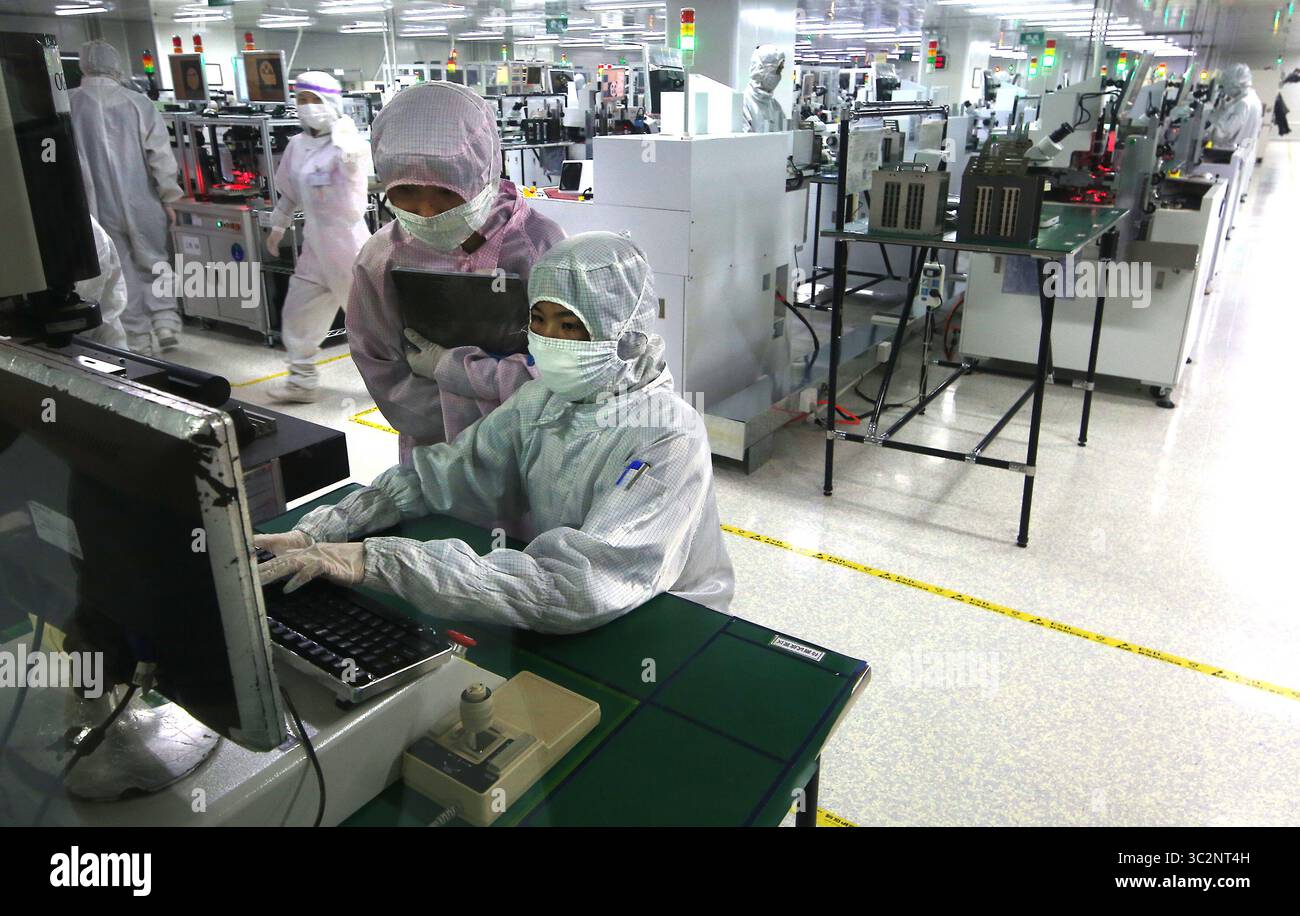 8 mai 2019 - Dongguan, PROVINCE DU GUANGDONG, CHINE - les techniciens chinois travaillent dans une salle blanche de Ruigu Optical Network Communications, l'un des secteurs commerciaux sous surveillance américaine, à Dongguan, province du Guangdong, le 8 mai 2019. Le président américain Donald Trump a donné suite à sa menace de relever les tarifs douaniers sur les exportations chinoises, marquant une forte escalade des tensions entre les deux plus grandes économies du monde. (Crédit image : © Todd Lee/ZUMA Wire) Banque D'Images