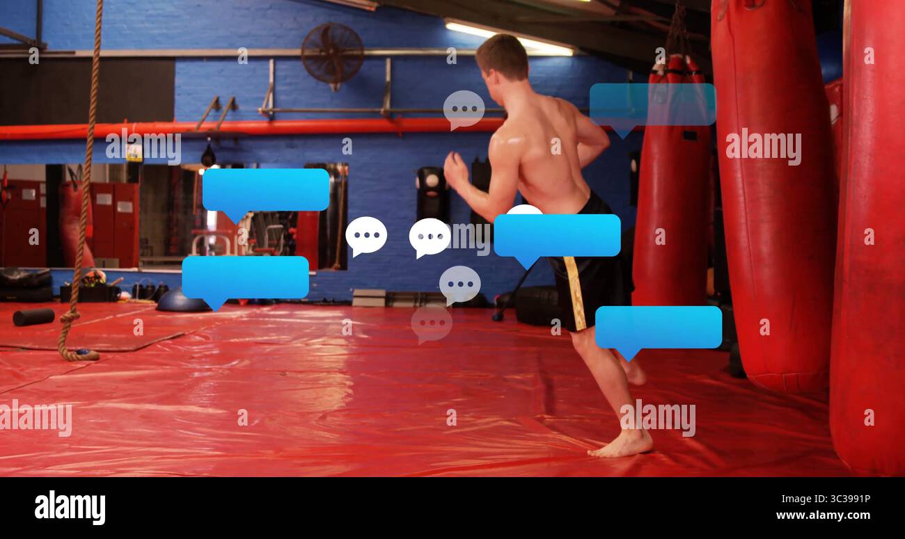 Artiste martial sans torse debout en short noir face à des sacs de poinçonnage dans le dojo, espace de copie Banque D'Images Artiste martial sans torse debout en short noir face à des sacs de poinçonnage dans le dojo, espace de copie Banque D'Images