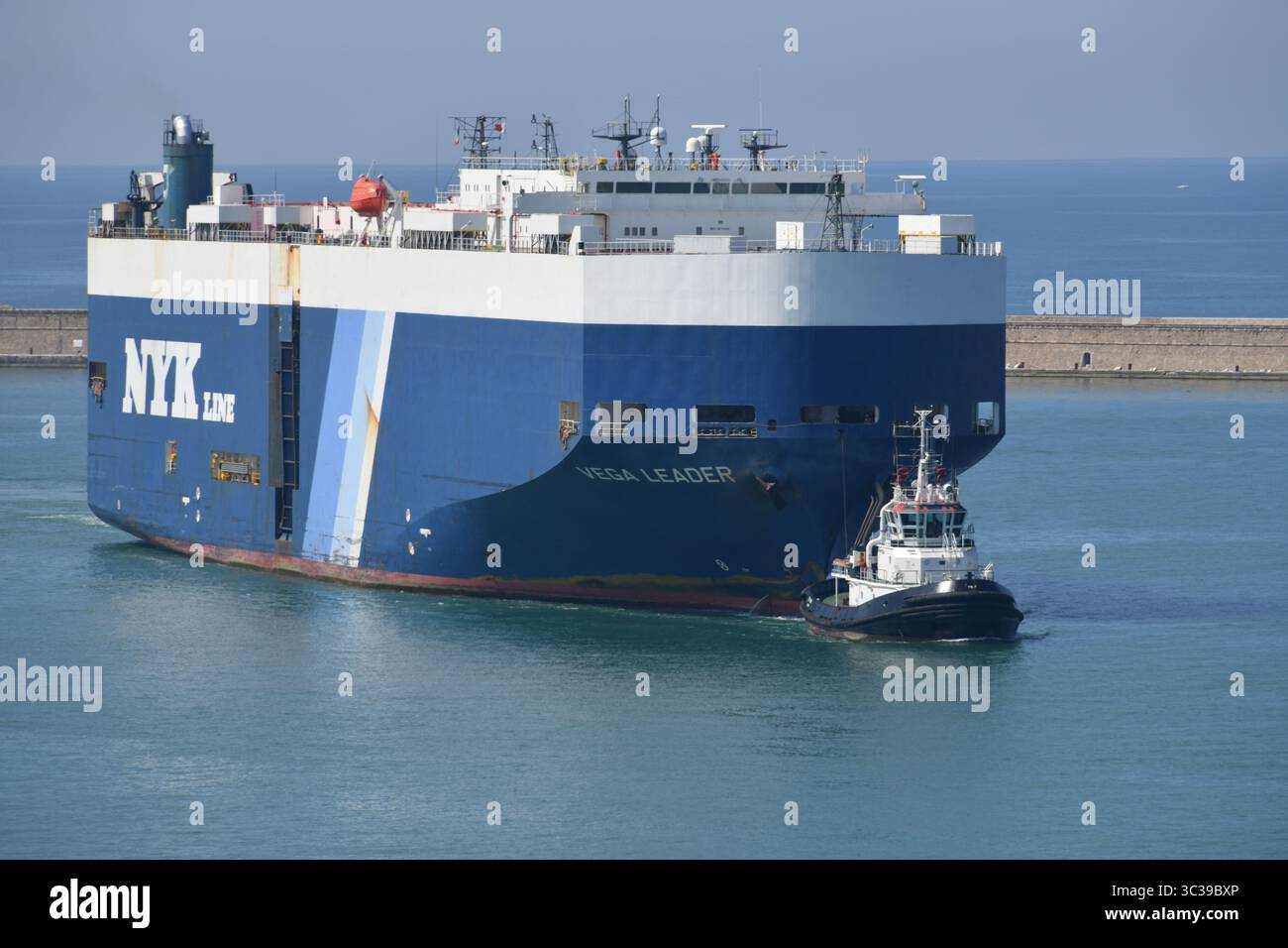 NYK Line Cargo ship Vega leader entre dans le port de Livourne, en Italie du Nord, le 23 juin 2025 avec le remorqueur Tito Neri Banque D'Images