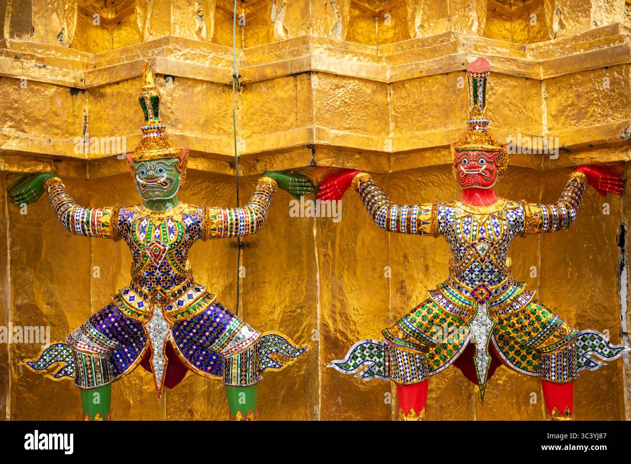 Sculptures de démons Yaksha sur les pagodes dorées à l'extérieur du temple du Bouddha d'émeraude, Wat Phra Kaew dans le Grand Palais Royal, Bangkok, Thaïlande Banque D'Images