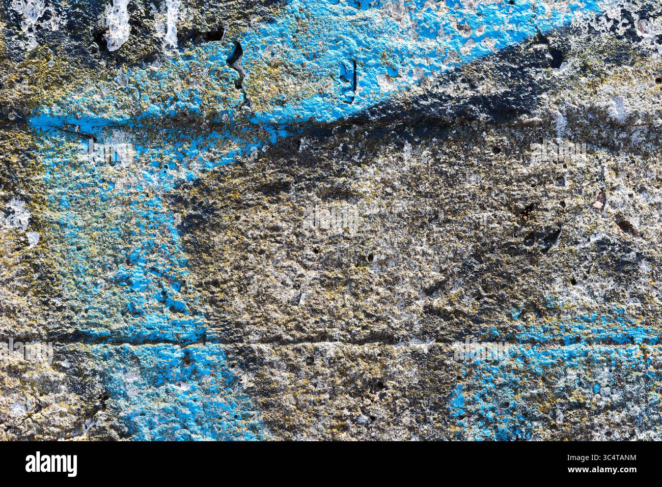 Surface fissurée présentant un mélange de textures peintes grises et bleues, offrant une esthétique rustique idéale pour les arrière-plans ou les projets artistiques créatifs. Le ro Banque D'Images