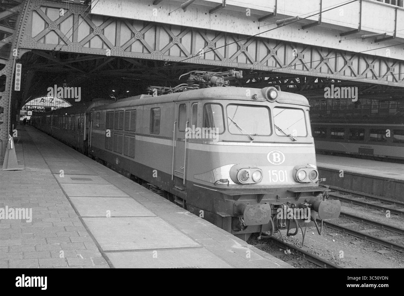 TEE express Amsterdam CS, chemins de fer, 15-03-1984 Whizgle News, Dutch Desk, pays-Bas, 1950-2000 Une locomotive de train d'époque est stationnée sur un quai ferroviaire de style industriel, présentant son design distinctif et son nombre important, entourée d'une structure en acier complexe. Banque D'Images