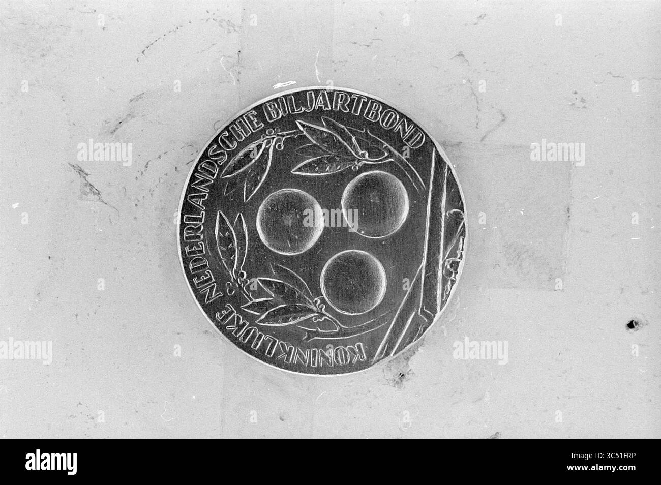 Joueur de billard Nobels, personnes, 14-12-1965 Whizgle News, Dutch Desk, pays-Bas, 1950-2000 Une médaille circulaire en métal présente trois formes sphériques centrées au milieu de feuilles délicatement gravées. L'inscription autour du bord indique « Nederlandsche Biljartbond », indiquant un lien avec l'association néerlandaise de billard. Banque D'Images