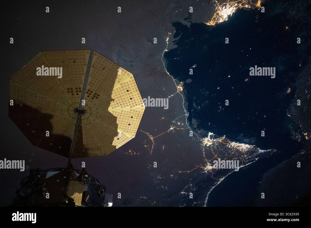 5 mai 2020, Emirats Arabes Unis : cette image nocturne de la Station spatiale internationale montre la ville de Doha, au Qatar (en haut à droite) dans le golfe Persique et les villes d'Abu Dhabi, Dubaï et Ali Ain (en bas à droite) dans les Emirats Arabes Unis. Au premier plan, se trouve l'un des panneaux solaires UltraFLex en forme de cymbale qui alimente le cargo spatial Cygnus de Northrop Grumman. (Crédit image : © NASA/ZUMA Wire/ZUMAPRESS.com) Banque D'Images