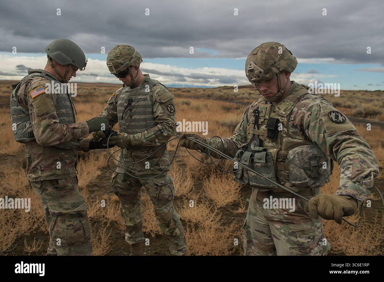 30 décembre 2020 - Boise, Idaho, États-Unis - SPCS. Timothy Martin (à gauche) et Shane Flores collent ensemble les explosifs C4 en préparation de la détonation tandis que le caporal Dario Martinez empêche les fusées de s'emmêler. La dernière semaine d'entraînement commence par une excursion d'une journée balayée par la pluie froide au centre d'entraînement de combat Orchard. Les stagiaires scouts conduiront à tour de rôle un véhicule de combat Bradley. Sur le champ de tir, les stagiaires tireront le lance-grenades-mitrailleuses Mark 19, le 50 Cal. Mitrailleuse et mitrailleuse 240B. Pendant le reste de la semaine, ils apprennent à poinçonner le canon de 25 mm ; les principes fondamentaux de Banque D'Images