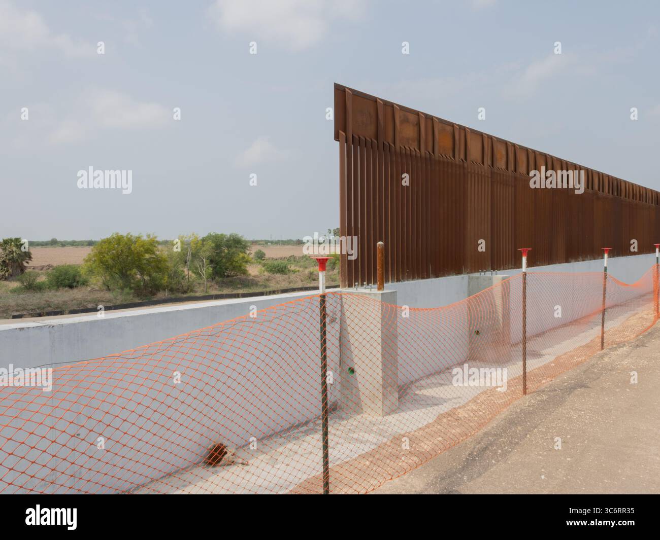 Le mur frontalier américano-mexicain à Donna, Texas, avec une vue dégagée à travers le Rio Grande jusqu'à Rio Bravo, Mexique, illustrant la frontière internationale. Banque D'Images