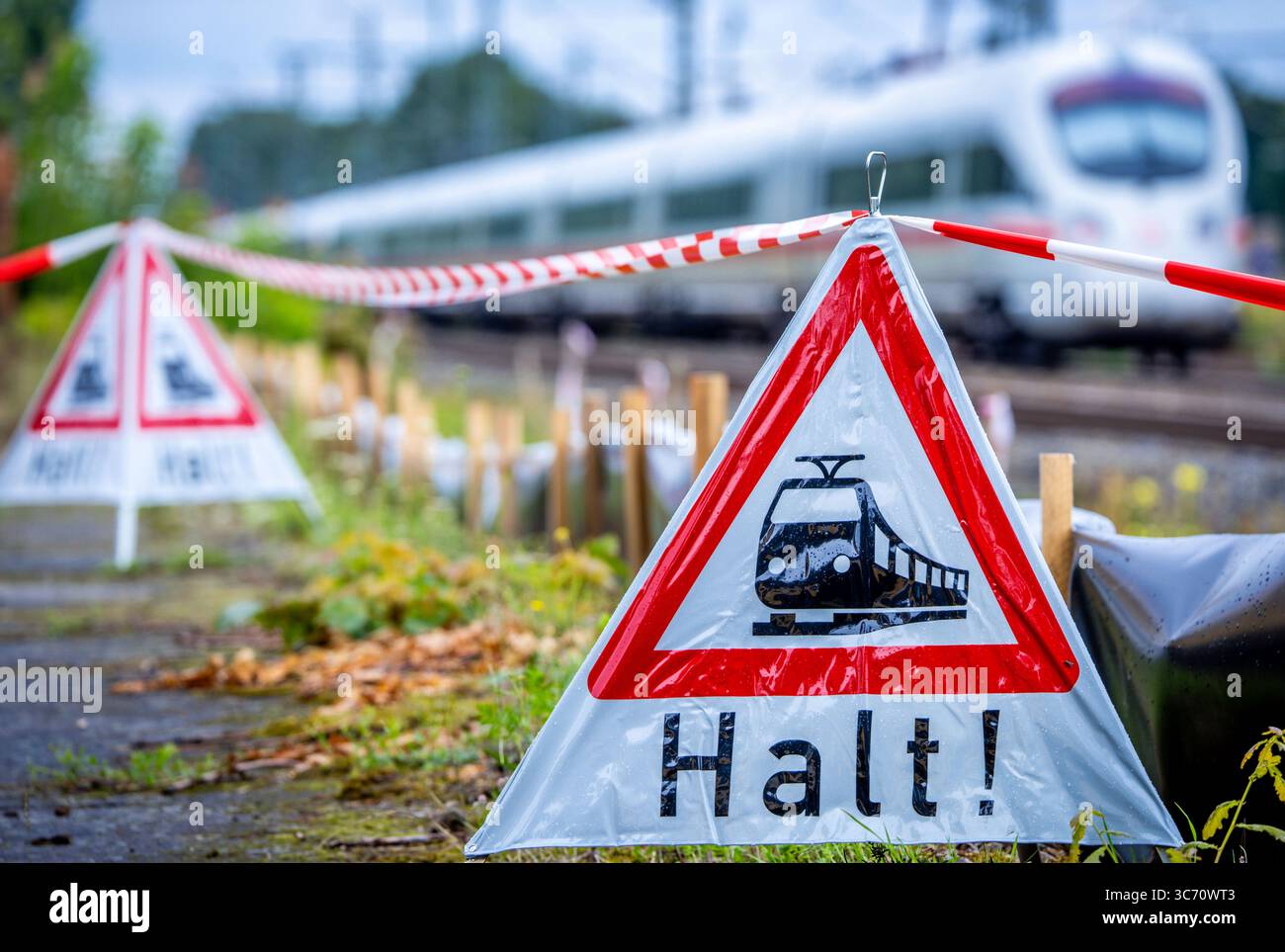 Ludwigslust, Allemagne. 01 août 2025. L'un des derniers trains ICE avant la fermeture de la ligne sort de la gare derrière des panneaux d'avertissement indiquant "Stop" avant le début du projet de rénovation de neuf mois pour la section de la ligne de chemin de fer entre Berlin et Hambourg. La ligne à double voie sera complètement fermée et réparée jusqu'en avril 2026. Avec 230 trains et jusqu'à 30 000 passagers par jour, la ligne d'environ 280 kilomètres est l'une des liaisons ferroviaires directes les plus importantes. Crédit : Jens Büttner/dpa/Alamy Live News Banque D'Images