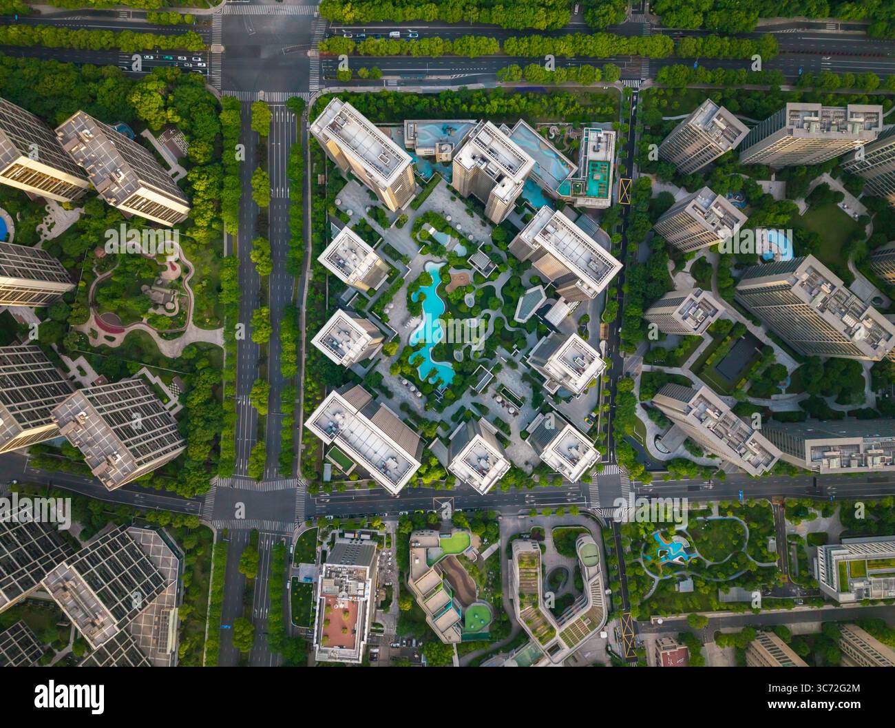 Vue aérienne de haut en bas du quartier résidentiel moderne avec verdure, éléments aquatiques et espaces de loisirs en milieu urbain. Banque D'Images