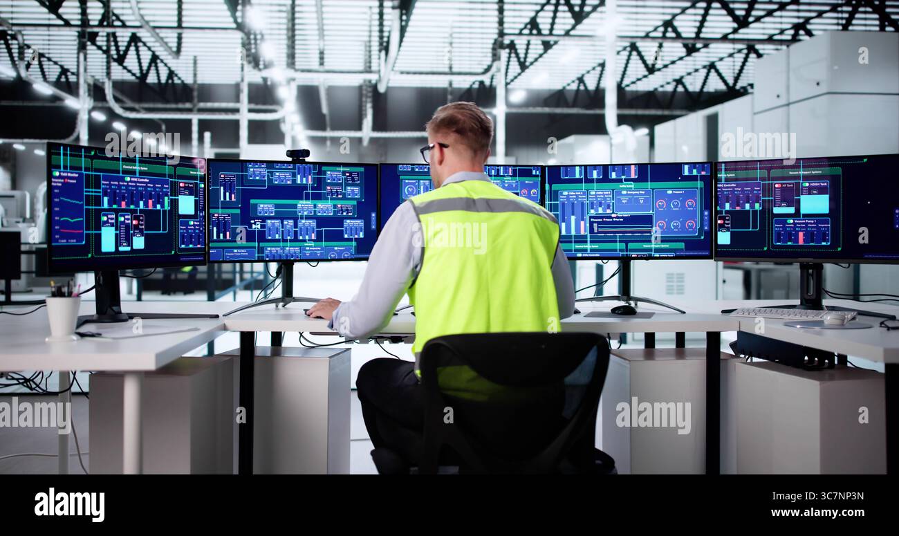 L'opérateur de contrôle de processus surveille les machines industrielles à l'aide d'un logiciel informatique Banque D'Images