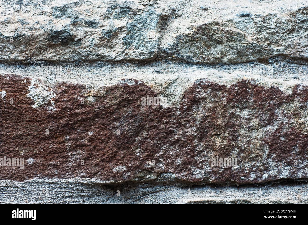 Gros plan d'un mur de pierre altérée. Texture, arrière-plan. Banque D'Images