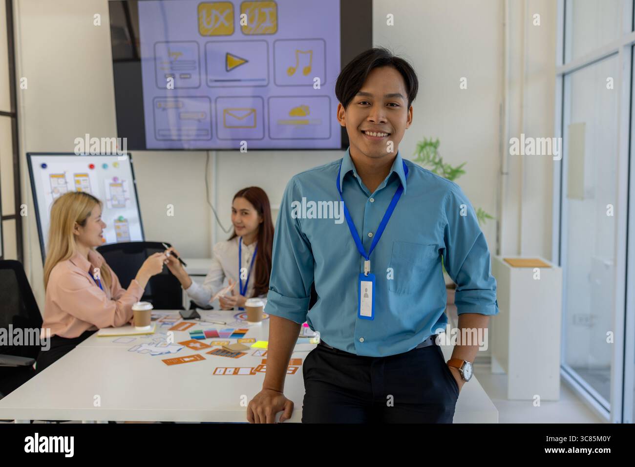 ux, ui, concepteur d'applications mobiles regarde la caméra, concepteur web regarde la caméra, environnement de travail dans le bureau du web et application mobile Banque D'Images