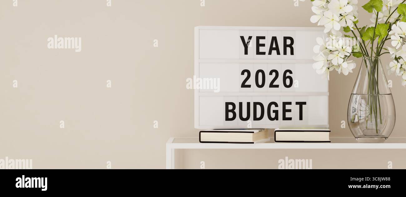 Une visionneuse affichant les mots « budget de l'année 2026 » sur une étagère avec des livres et des plantes. Espace de copie, format de bannière Web. Banque D'Images