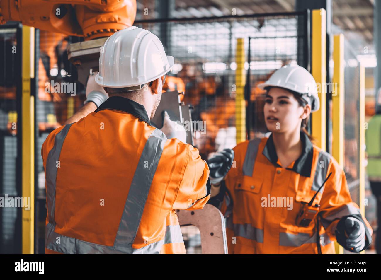 Service d'équipe d'ingénieur soudage de robot travaillant dans l'usine d'automatisation. Machine de robot de contrôle de travail de sécurité des travailleurs de personnes dans la technologie de l'industrie lourde. Banque D'Images