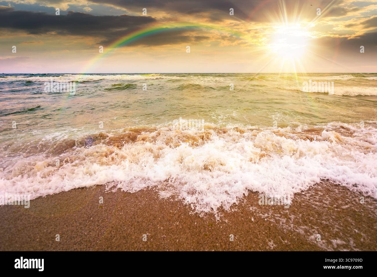 marée marine avant tempête au coucher du soleil. éclaboussure de vague avec de la mousse sur la plage de sable humide à la lumière du soir. temps venteux sur la saison du velours. spectaculaire grou de paysage marin Banque D'Images