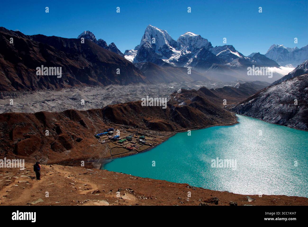 Les randonneurs grimpent Gokyo Ri ( Gokyo Peak ) au Népal - avec en toile de fond le troisième lac de la spectaculaire vallée de Gokyo. Cette vallée est de plus en plus un in Banque D'Images Les randonneurs grimpent Gokyo Ri ( Gokyo Peak ) au Népal - avec en toile de fond le troisième lac de la spectaculaire vallée de Gokyo. Cette vallée est de plus en plus un in Banque D'Images