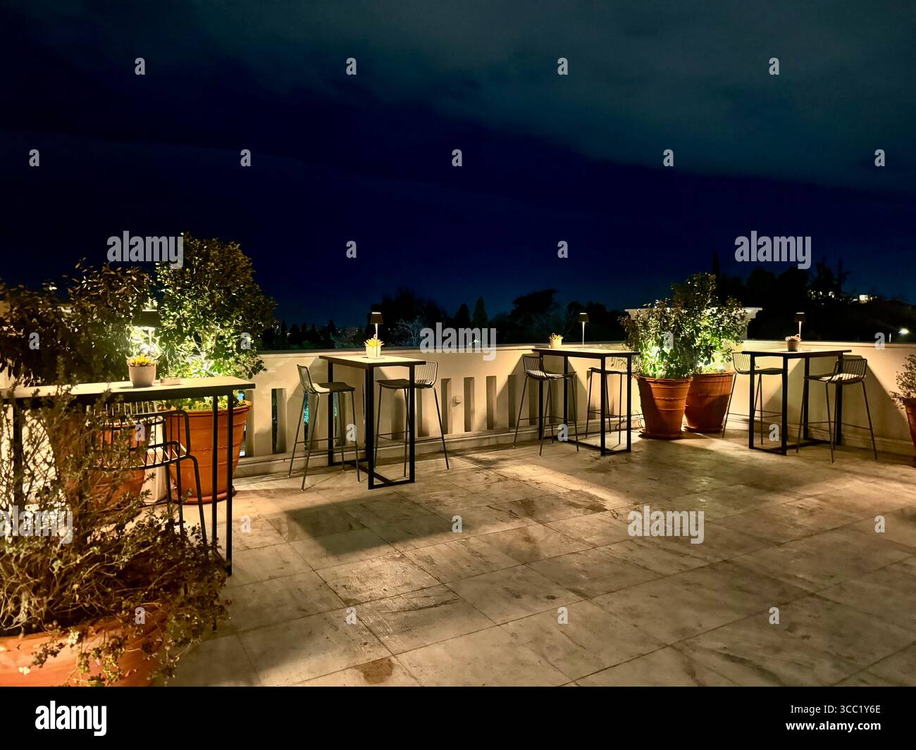 Vue nocturne sur le toit-terrasse du Museu Benaki à Athènes, dotée de sièges extérieurs et d'un éclairage d'ambiance. Banque D'Images