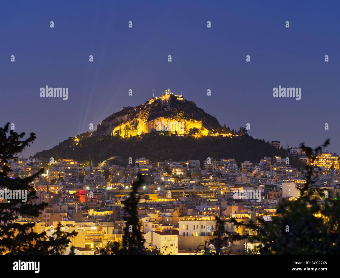 Majestueuse vue nocturne de la colline de Lycabette surplombant la ville illuminée d'Athènes après l'heure bleue, Grèce Banque D'Images