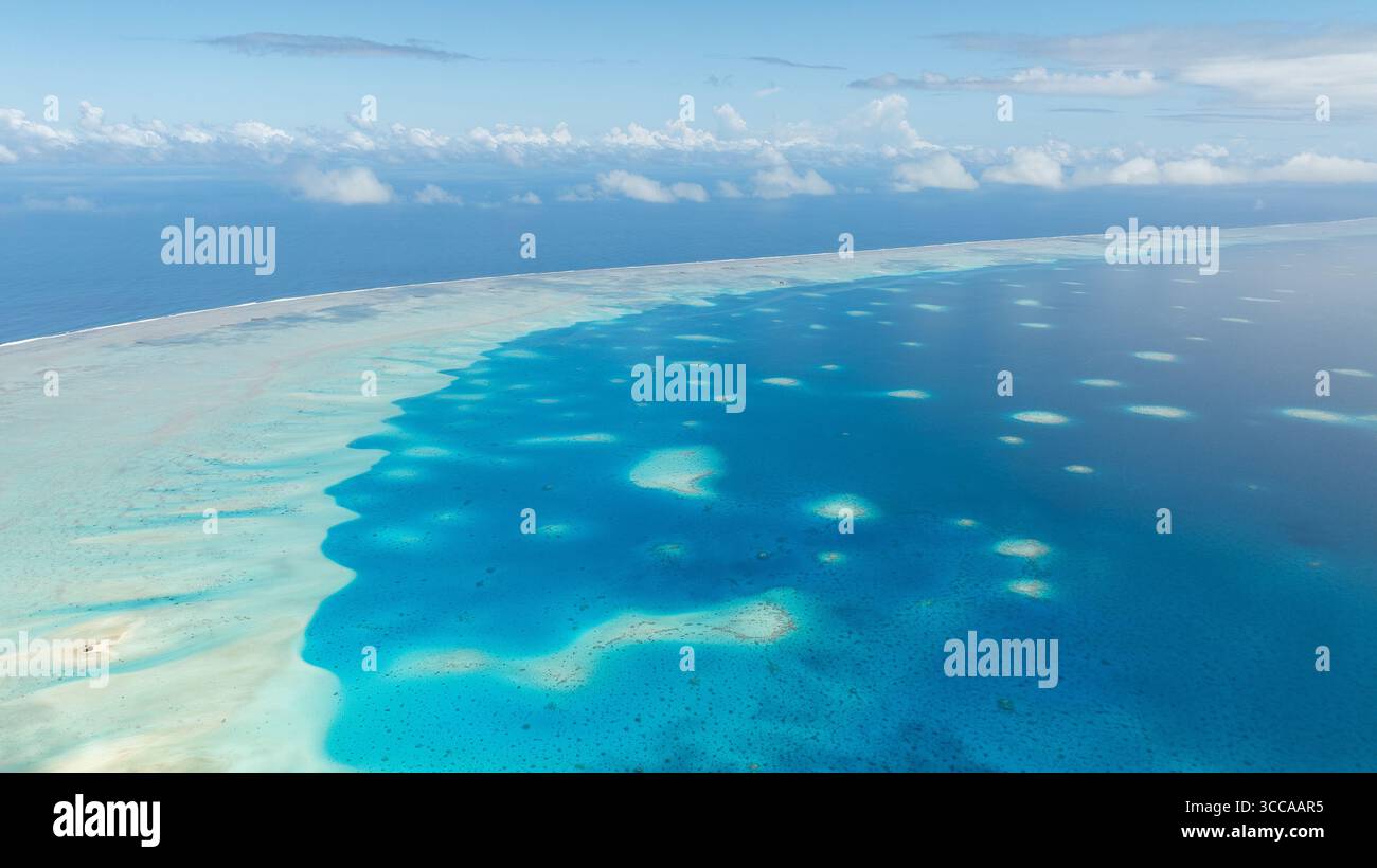 Vue aérienne des eaux turquoises rencontrant la mer bleu profond dans une exposition étonnante de beauté naturelle, Fakarava, Iles Tuamotu-Gambier, Polynésie française. Banque D'Images