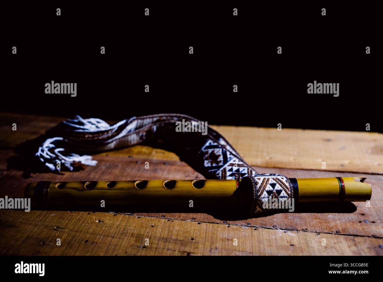 Flûte andine et cornemuse, instruments de musique traditionnels des Andes sur bois avec un fond noir Banque D'Images