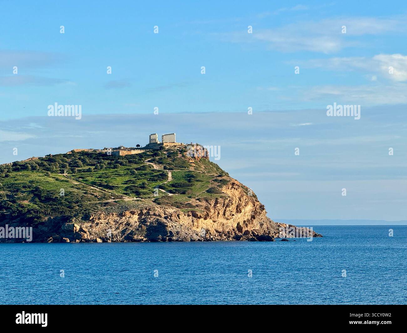 Vue du temple de Poséidon au cap Sounion en Grèce, vu de loin à travers la mer Égée. Banque D'Images