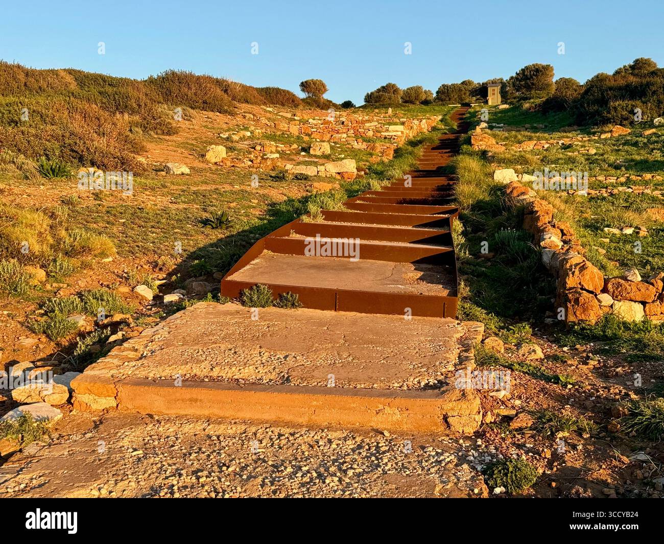 La lumière de l'heure d'or baigne le site archéologique de Sounion, en Grèce, y compris les sentiers et les ruines près du temple de Poséidon. Banque D'Images
