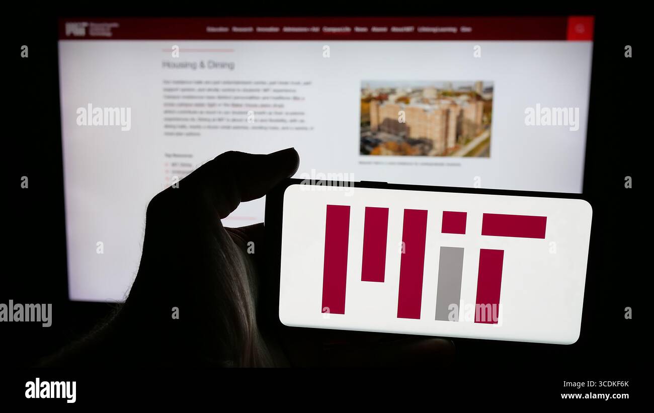 Stuttgart, Allemagne - 08-01-2025 : personne tenant un téléphone portable avec le logo du Massachusetts Institute of Technology (MIT) sur l'écran devant la page Web. Banque D'Images