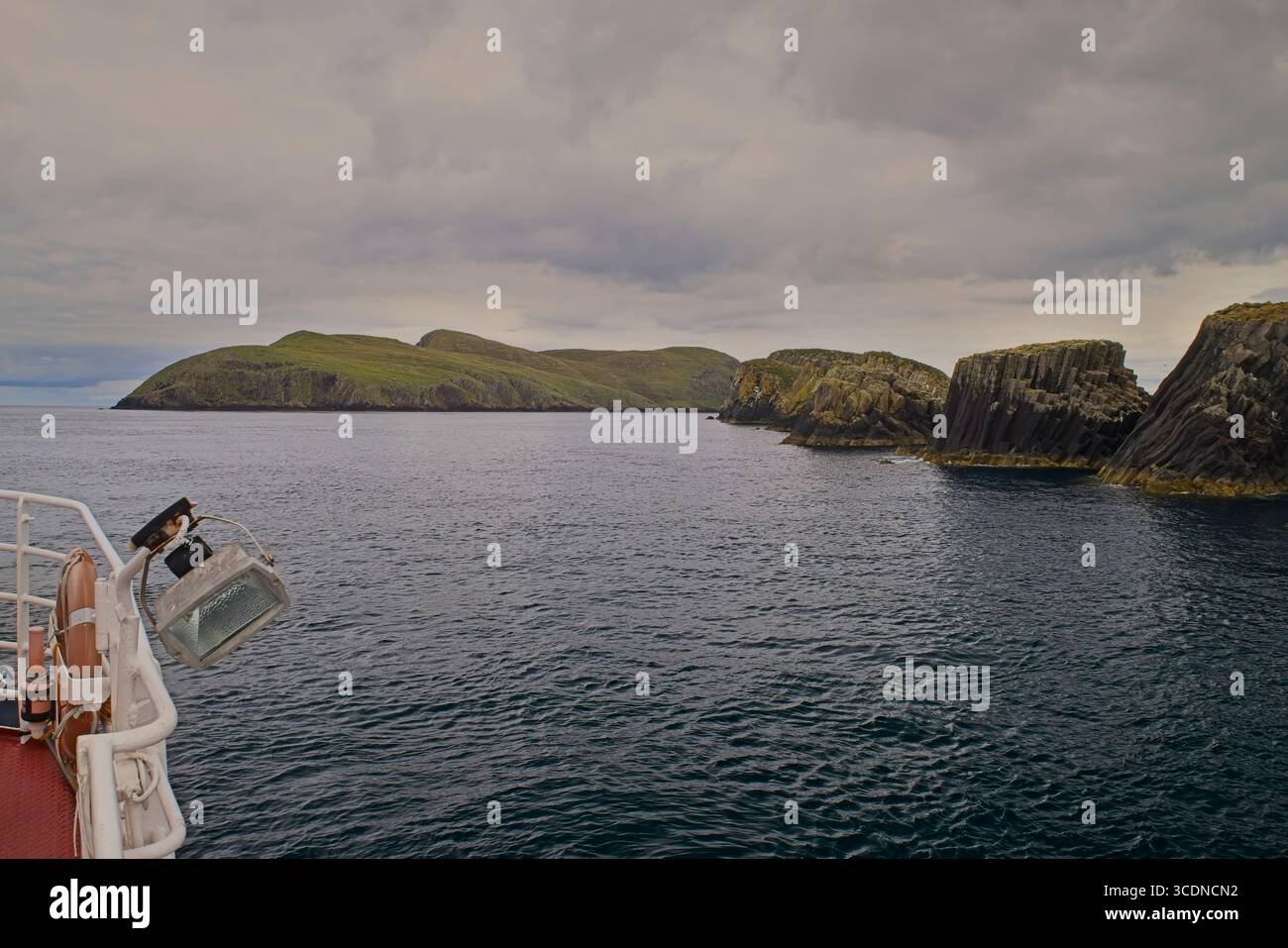 Approche des îles Shiant (Na h-Eileanan Shianta) en bateau depuis Harris, Hébrides extérieures, Écosse, avec ciel nuageux et mer calme. Banque D'Images