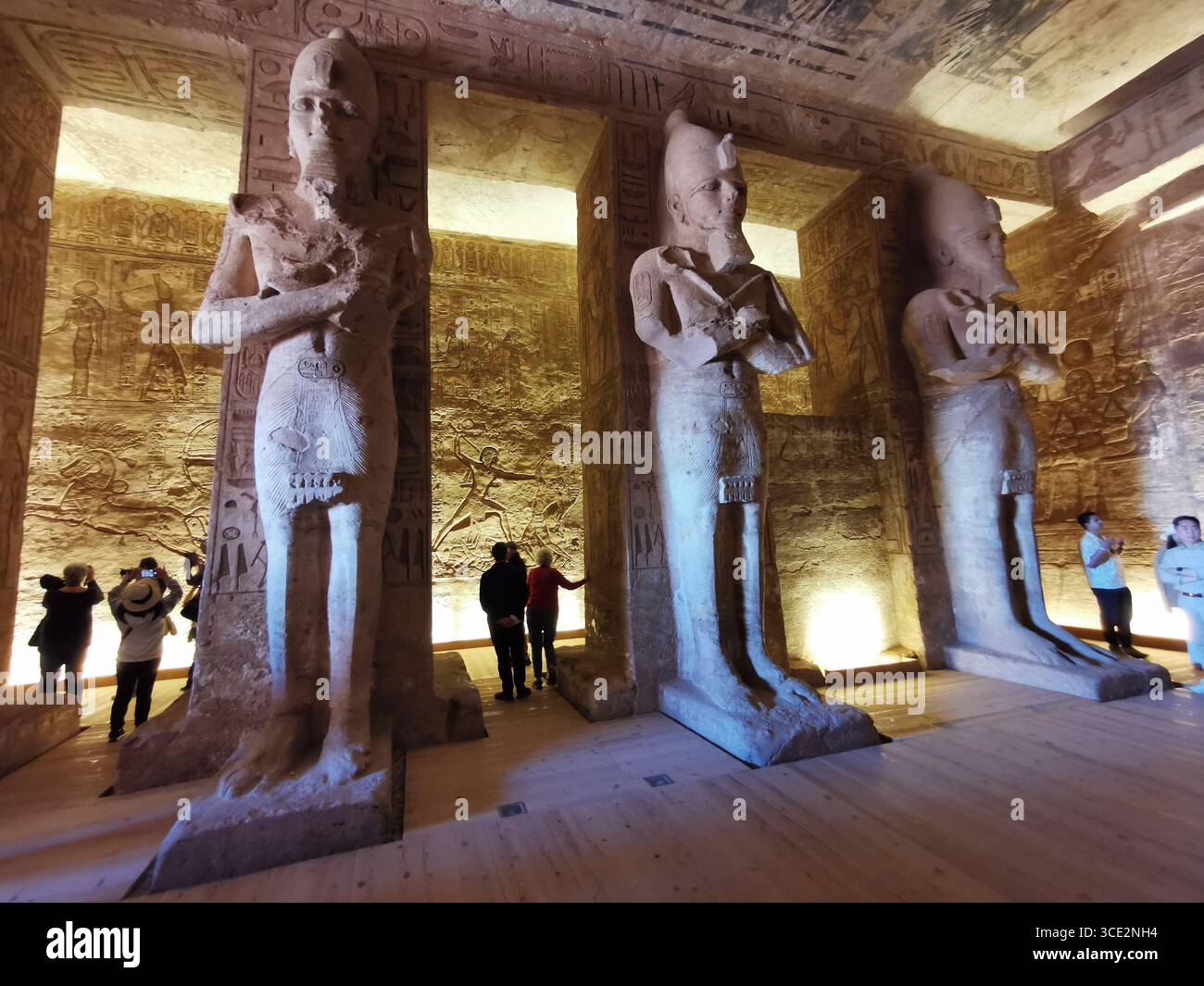 À l'intérieur du temple d'Abu Simbel. Vue de la salle hypostyle avec huit statues colossales piliers de Ramsès II. touristes inclus pour l'échelle. - Image de stock capturée avec un smartphone