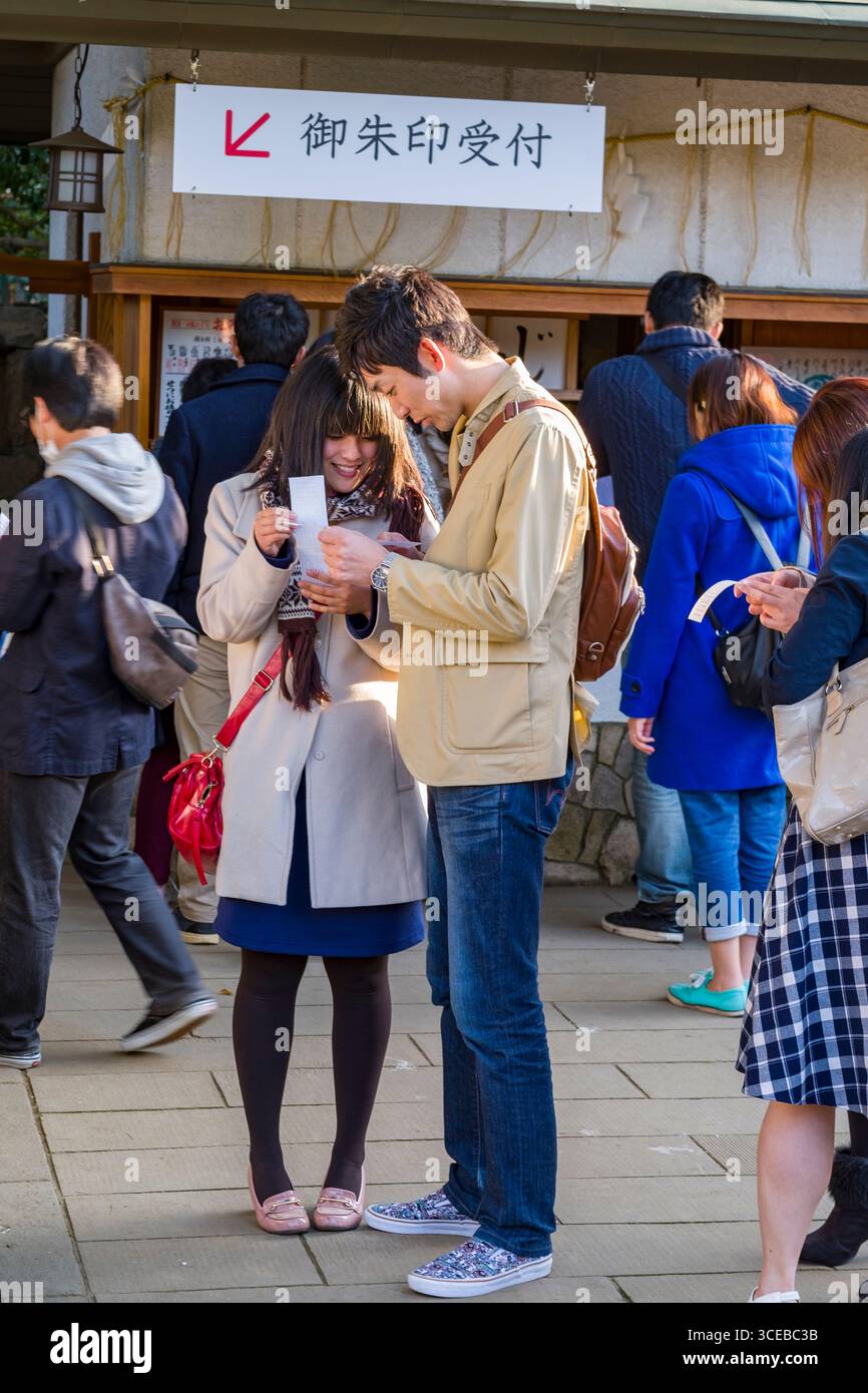 Jeune homme japonais et femme lisant un livre blanc remarque, Toshogu, le parc Ueno, Taito, Tokyo, Honshu, Japan Banque D'Images