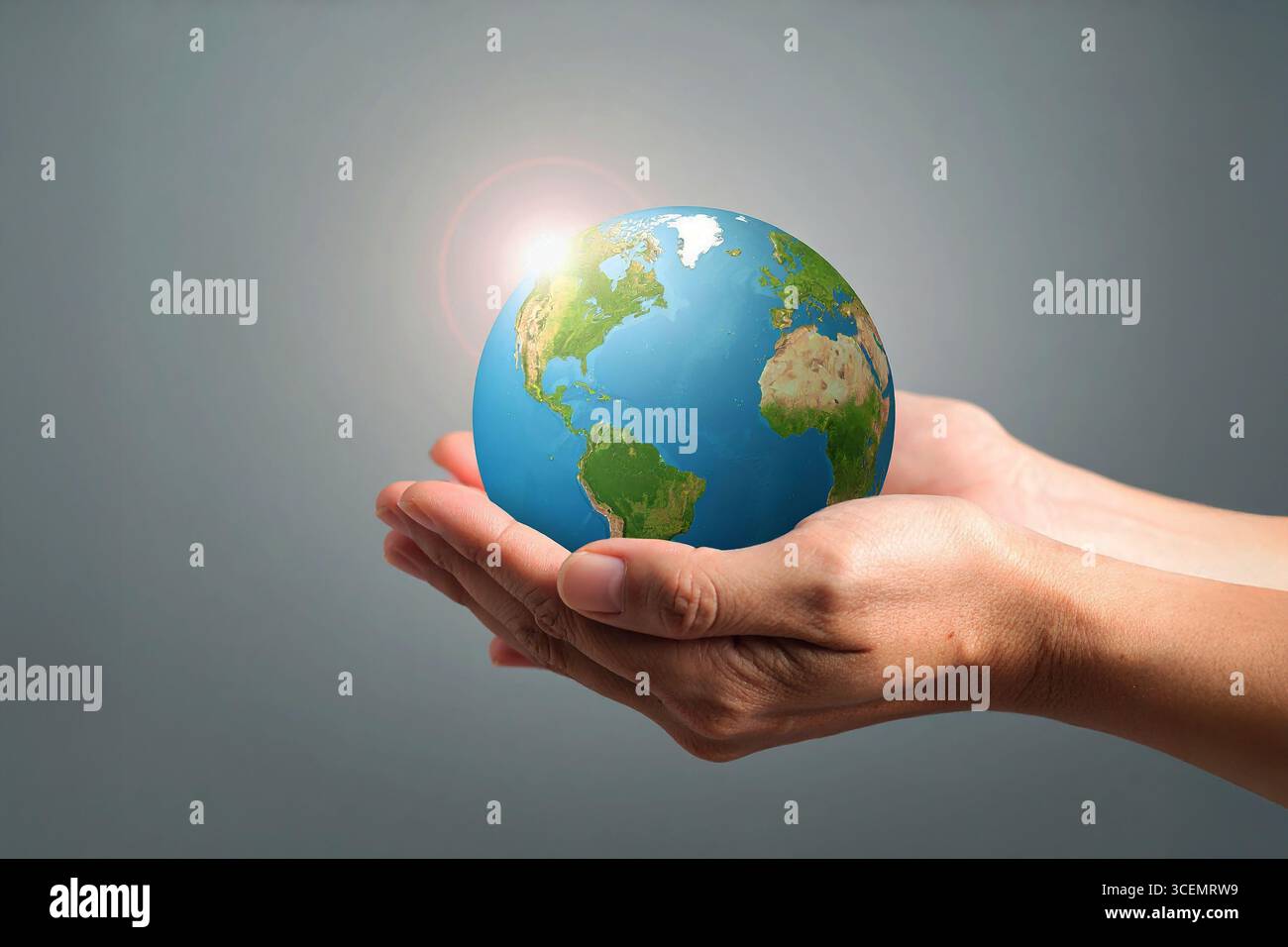 Mains humaines berçant la Terre, symbolisant l'harmonie, la responsabilité écologique et l'espoir d'un monde durable. Banque D'Images