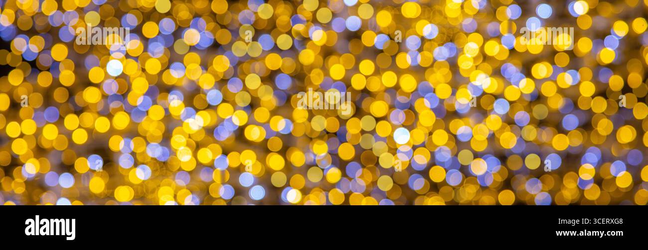 Lumières bokeh jaunes et bleues festives créant un beau fond abstrait, parfait pour les célébrations et les vacances Banque D'Images
