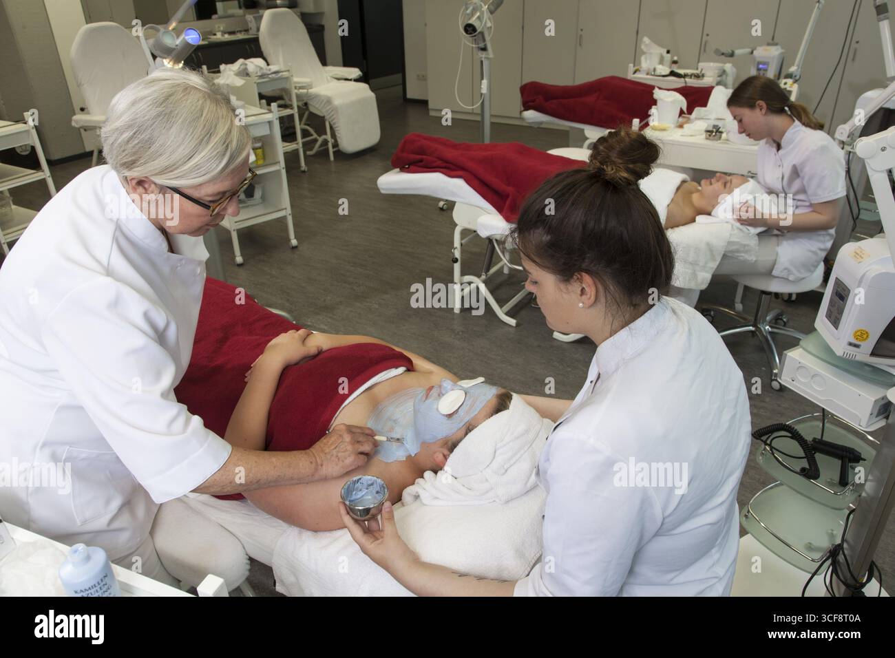Application du masque facial bleu à l'azulène dans les leçons pratiques. Formation d'esthéticienne à l'école professionnelle de Duesseldorf, Rhénanie-du-Nord-Westp Banque D'Images