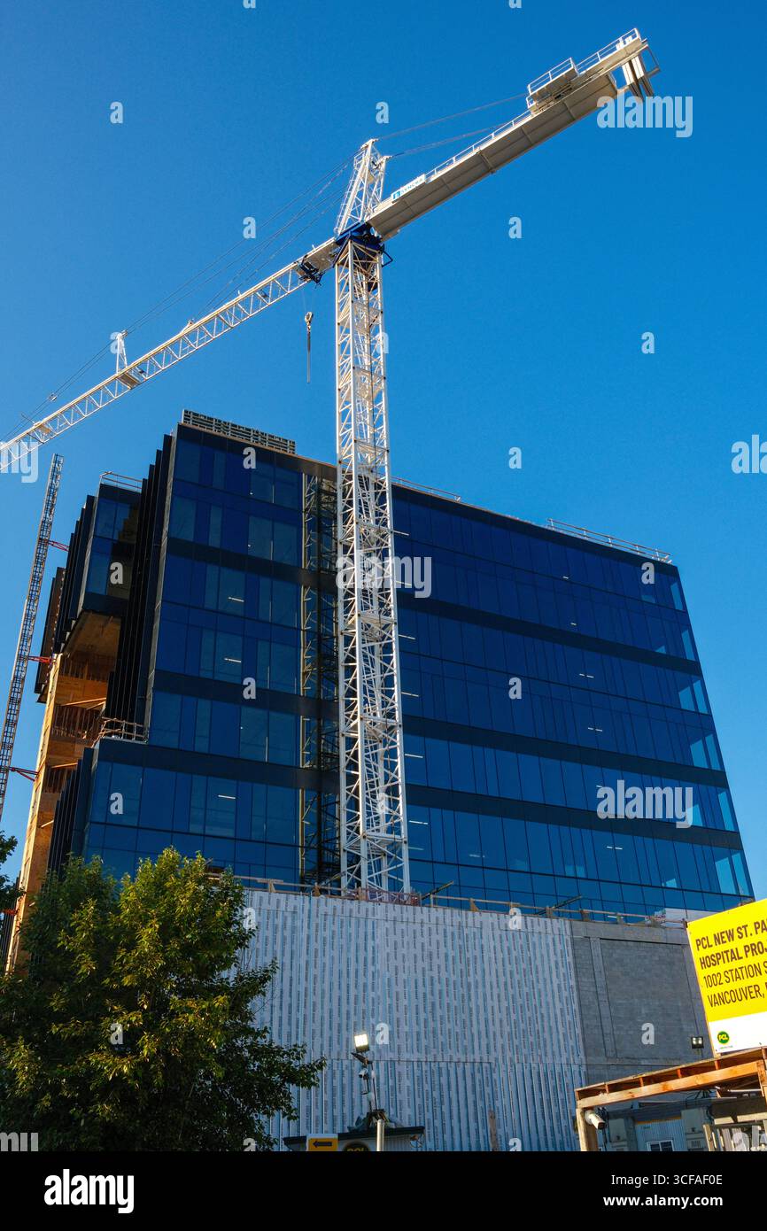 Une grue de bâtiment par la nouvelle construction d'un immeuble de bureaux à East Vancouver, C.-B. Banque D'Images