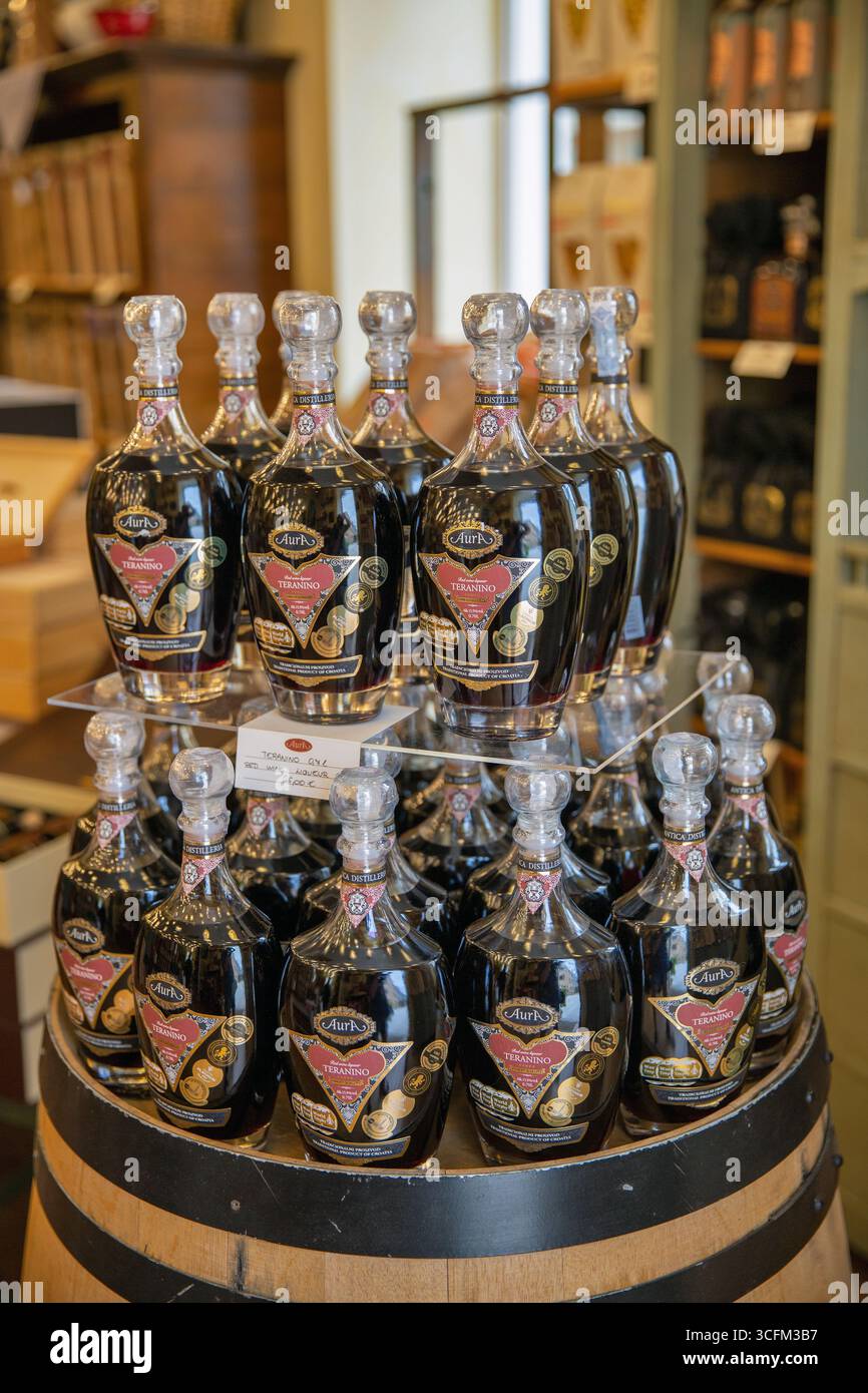 Novigrad, Croatie - 22 mai 2025 : bouteilles de liqueur de vin rouge aura Teranino avec des étiquettes traditionnelles affichées en gros plan dans une distillerie locale. Artisan Croati Banque D'Images