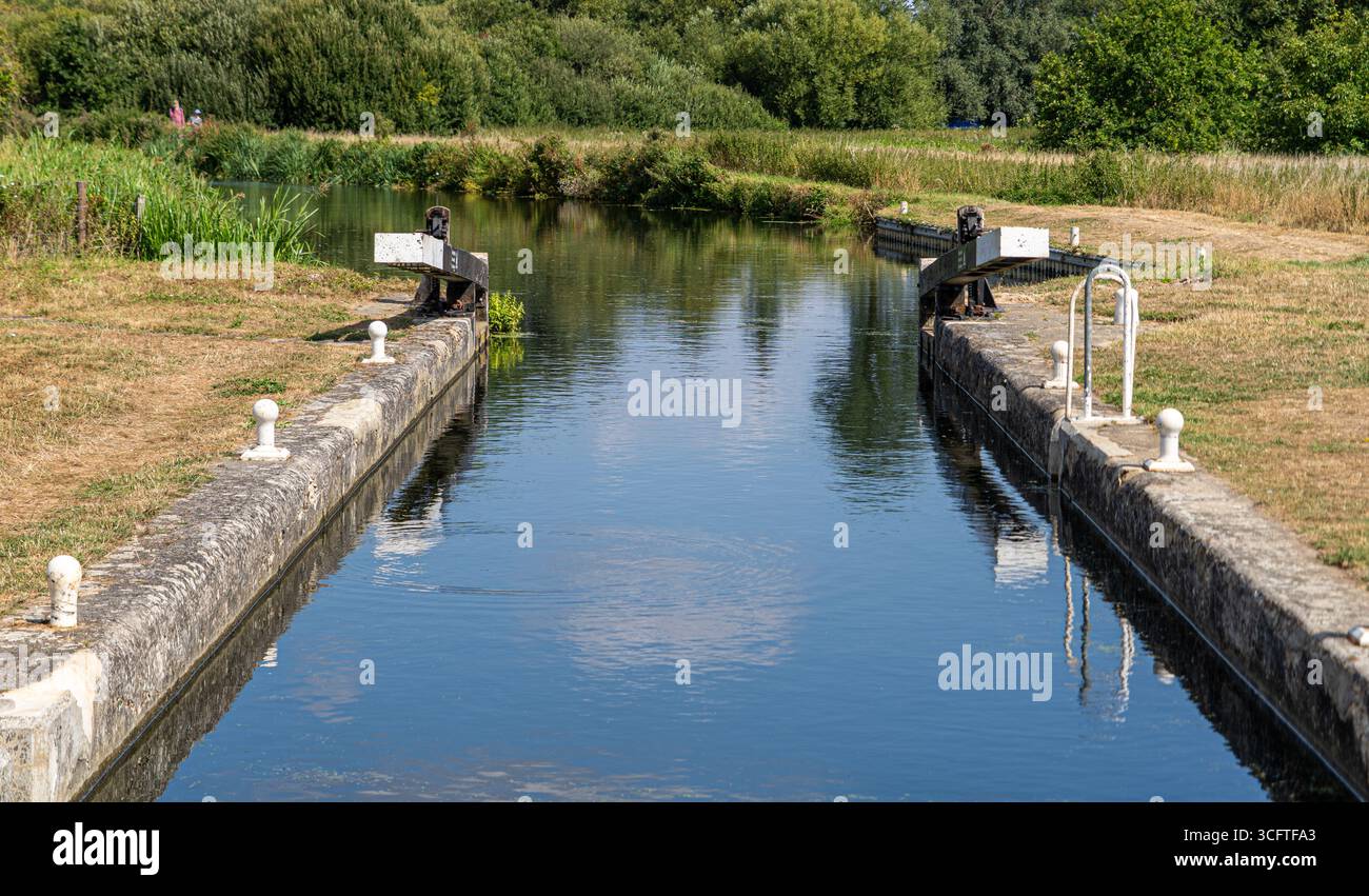 Scène estivale lumineuse d'écluses de canal, roseaux et surface miroitante Banque D'Images