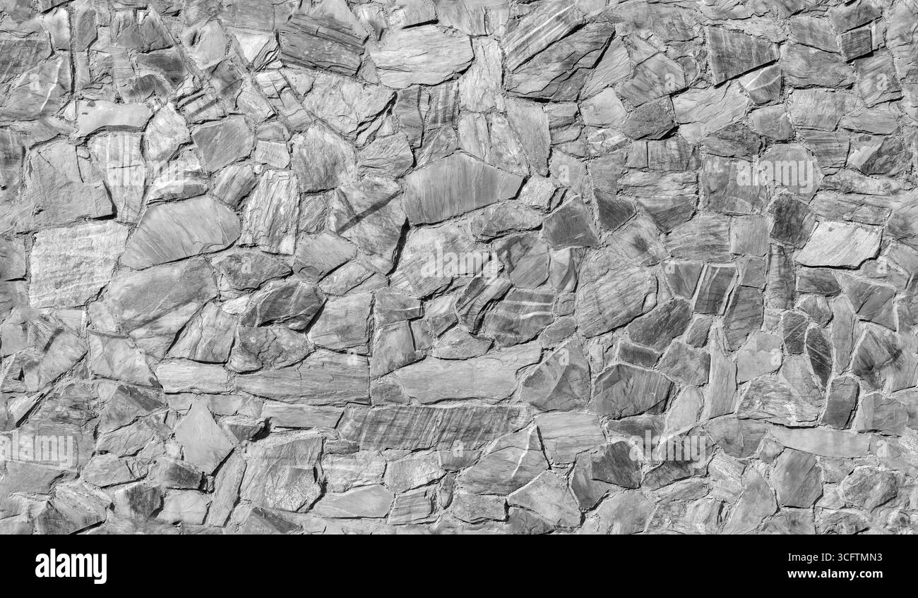 Motif mural en pierre grise mosaïque, vue de face, texture de photo de fond sans couture, noir et blanc Banque D'Images