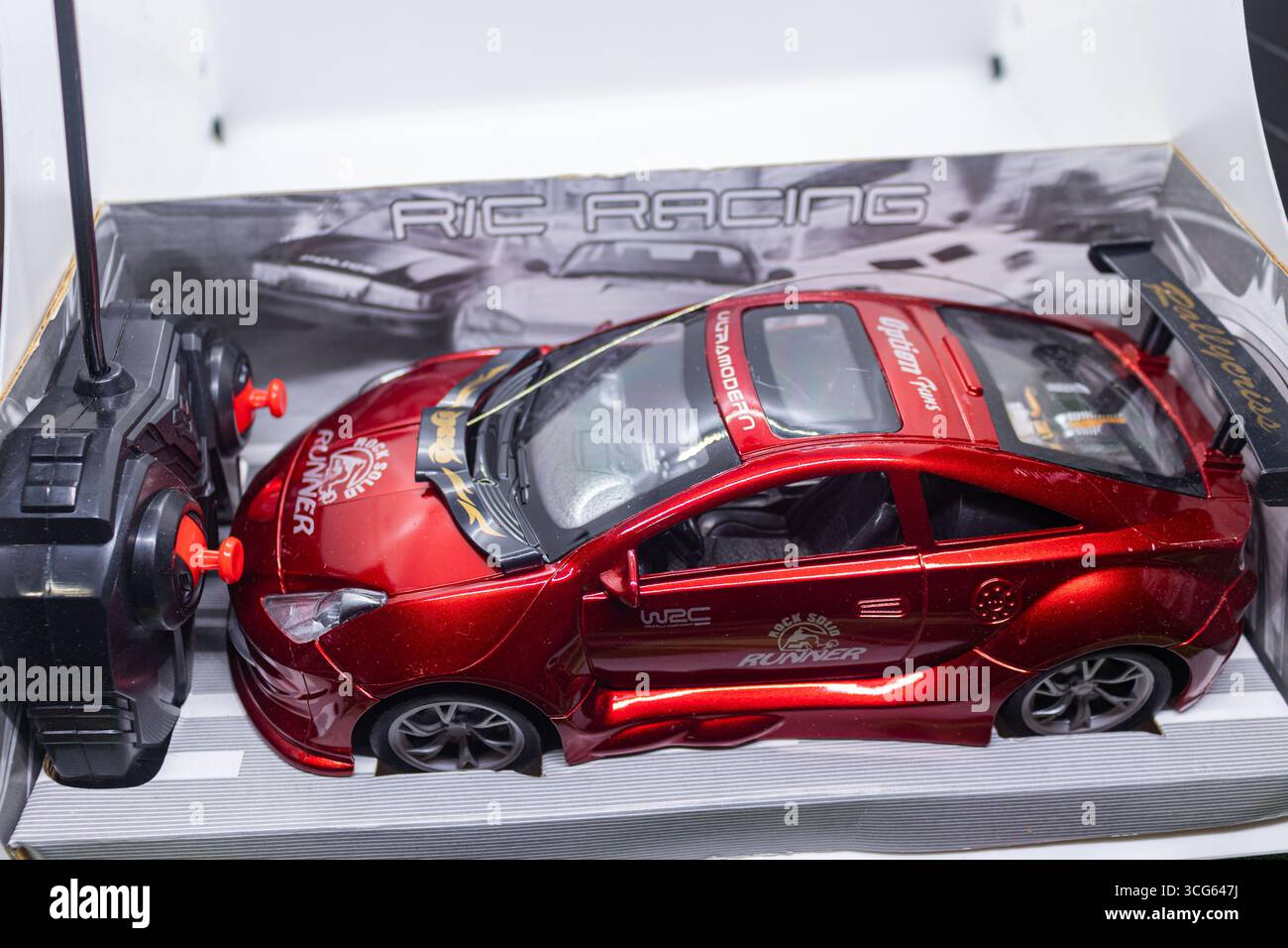 Gros plan d’un véhicule jouet rouge vif pour enfants. Construction en plastique durable conçue pour le jeu imaginatif et le plaisir de la petite enfance. Parfait pour les enfants Banque D'Images