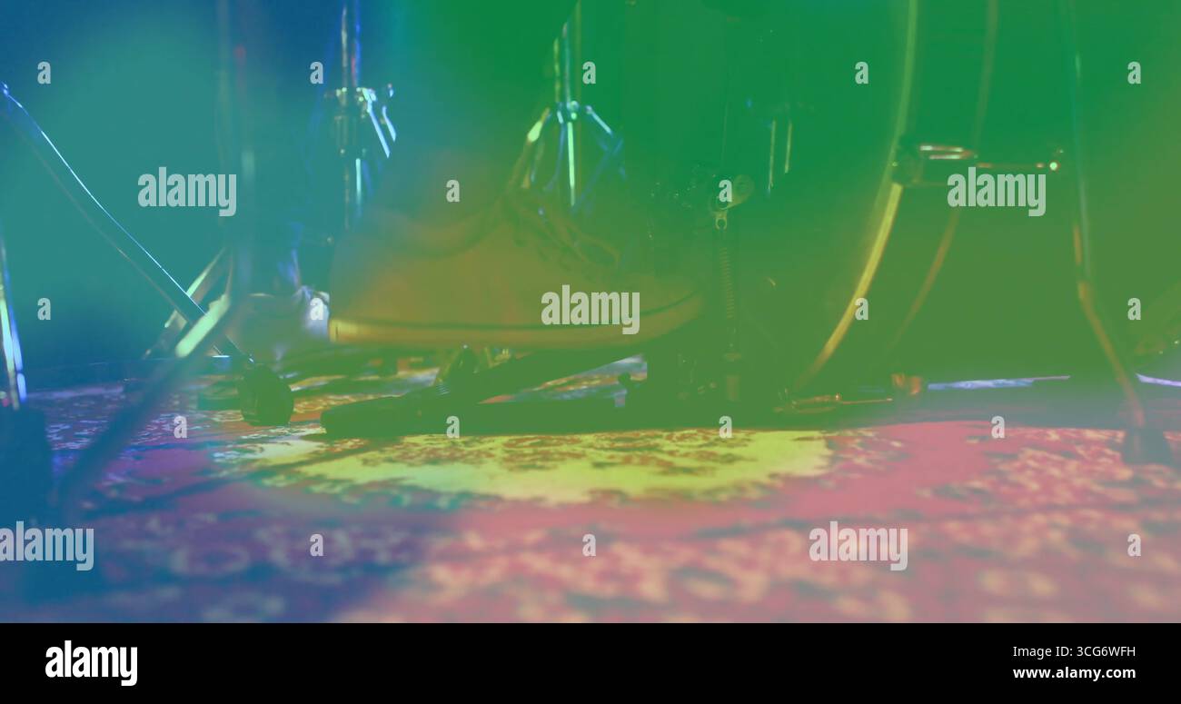 Botte à lacets marron clair sur la pédale de grosse caisse sur scène, avec tapis à motifs et éclairage coloré Banque D'Images